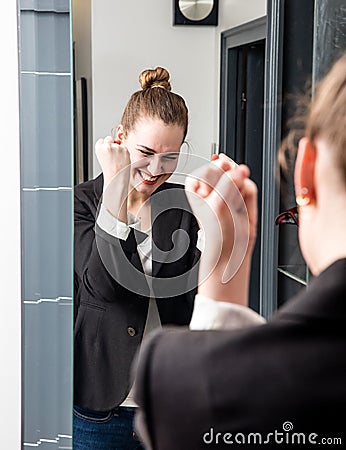 Thrilled smart young woman laughing with successful joyful body language Stock Photo