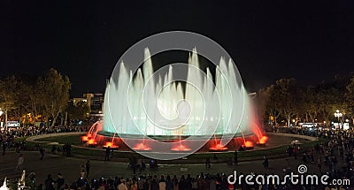 Throngs of people at the colourful light & water fountain show. Night in Barcelona, Spain, at the magic fountain. Editorial Stock Photo