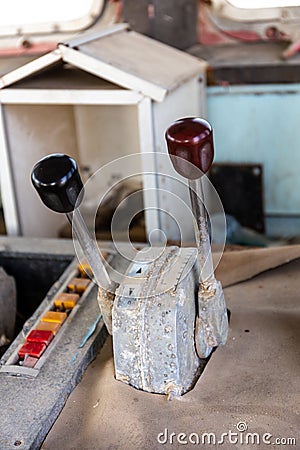 Throttle levers close-up in a wheelhouse of the abandoned, old cargo ship, inside view Stock Photo