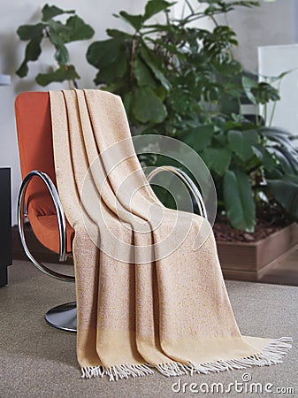 Throw draped over a chair Stock Photo