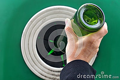 Throw a glass bottle into a container Stock Photo