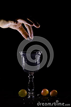 Throw grapes in a water-filled glass splash Stock Photo