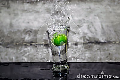 Throw lime into a glass of water Stock Photo