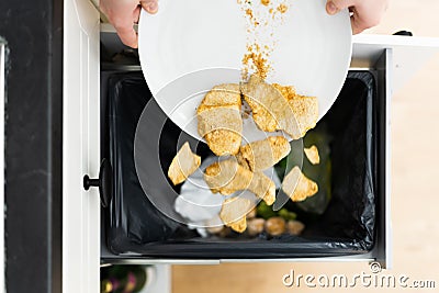 Throwing Away Leftover Food In Trash Stock Photo