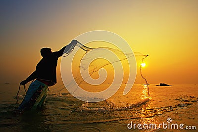 Throwing fishing net during sunset Stock Photo