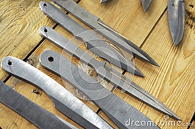 Throwing knives on wooden background Stock Photo