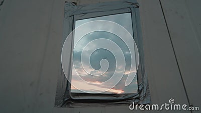 Thrown Out Old Mirror Hanging Against Wall With Sky Reflection Stock Photo