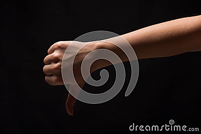 Thumb down sign isolated on black background Stock Photo