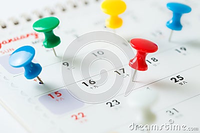 Thumb tack pin on calendar Stock Photo