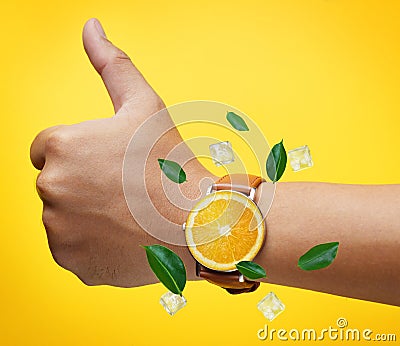 Thumb up Hand Wearing Fruit Orange Watch Green Leaves and Ice Cu Stock Photo