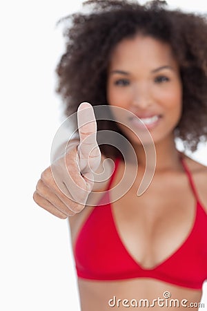 Thumbs up being shown by a young brunette woman Stock Photo