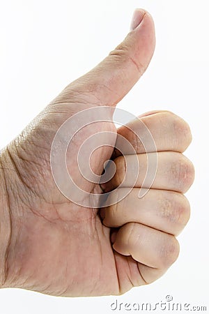 A thumbs up gesture performed by real humanCaucasian hand. This image can also be used to represent approval or acknowledgement. Stock Photo