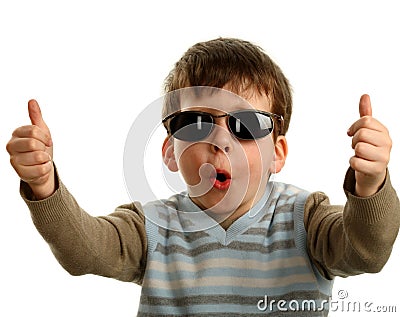 Thumbs up shown by a happy young boy on glasses Stock Photo