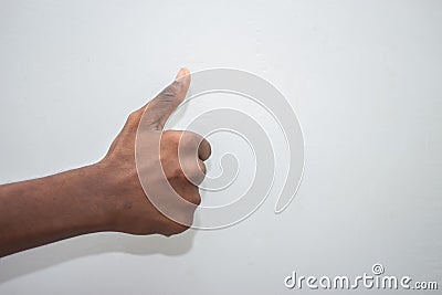 Thumbs up sign - Male hand showing thumbs up sign isolated on white background. Hand symbol sign language Stock Photo