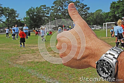 Thumbs up at soccer game Stock Photo
