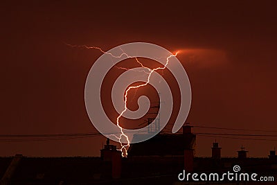 Thunder lightning over the city rooftops Stock Photo