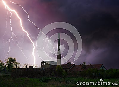 Thunder, lightning and storm over abandoned factory in summer Stock Photo