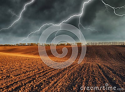 Thunderstorm in the field. huge lightning over a hilly field Stock Photo