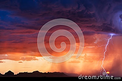 Thunderstorm lightning bolt strike at sunset Stock Photo