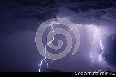 Thunderstorm with lightning bolts striking the Dragoon Mountains. Stock Photo