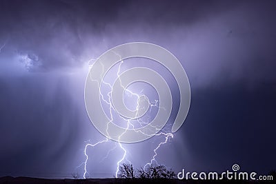 Thunderstorm and lightning bolts striking at night Stock Photo