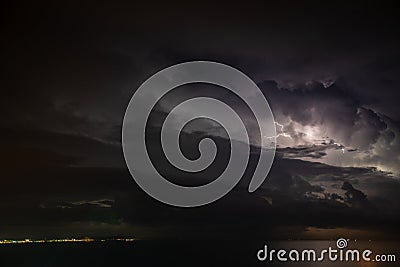 Thunderstorm over the sea, lightning beats the water Stock Photo