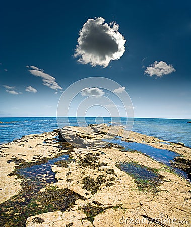 Thundery little cloud at shore Stock Photo