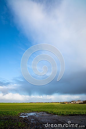 Thundery shower with rain streaks over the Dutch countryside Stock Photo