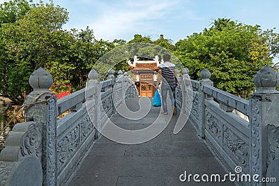 Thuy Trung Tien temple with stone bridge on Thanh Nien street in Hanoi, Vietnam Editorial Stock Photo