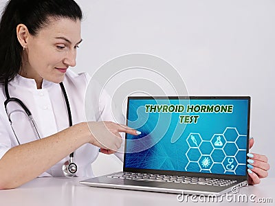 THYROID HORMONE TEST inscription on the screen. Close up internisthands holding pen Stock Photo