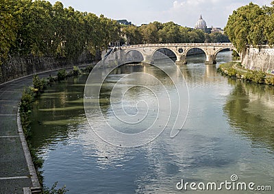 The Tiber River flowing through Rome with dome of Saint Peter`s Basilica Stock Photo