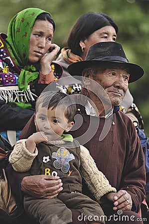 Tibetan family consisting of mother, aunt, nephew and grandfather dressed in traditional clothing at a festival in Ladakh Editorial Stock Photo