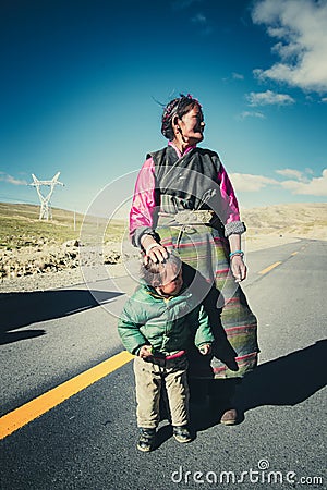 A Tibetan farmer with her kid Editorial Stock Photo