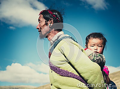 A Tibetan farmer with his kid Editorial Stock Photo