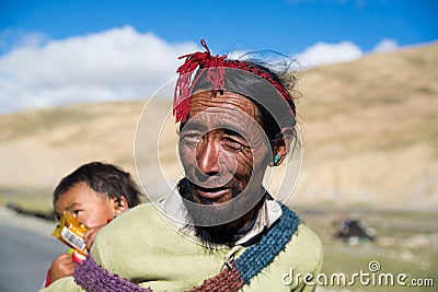 A Tibetan farmer with his kid Editorial Stock Photo