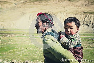 A Tibetan farmer with his kid Editorial Stock Photo