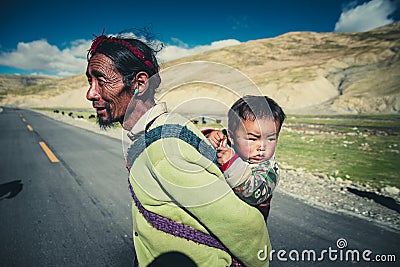 A Tibetan farmer with his kid Editorial Stock Photo