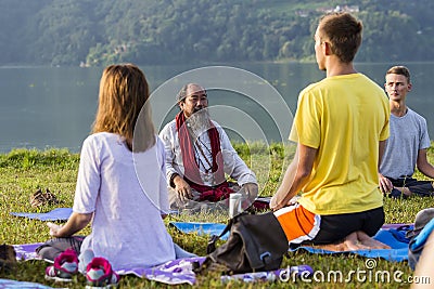 Tibetan Lama conducts classes with sunsurfers people on meditation and yoga. Pokhara, Nepal Editorial Stock Photo