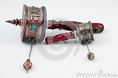 Tibetan portable prayer wheels on a white Stock Photo