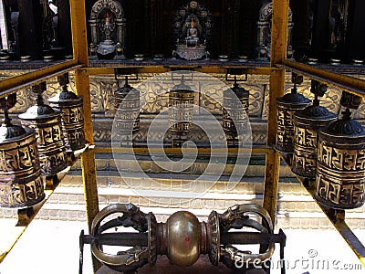 Tibetan prayer wheels inside Hiranya Varna Mahavihar. Golden Temple. Patan, Kathmandu. Nepal Stock Photo