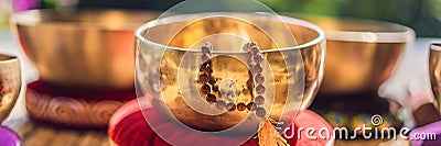 Tibetan singing bowls on a straw mat BANNER, LONG FORMAT Stock Photo