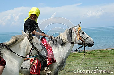 Tibetan woman riding horse Editorial Stock Photo