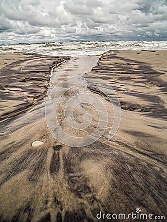 Tidal watercourse and marks on the beach Stock Photo