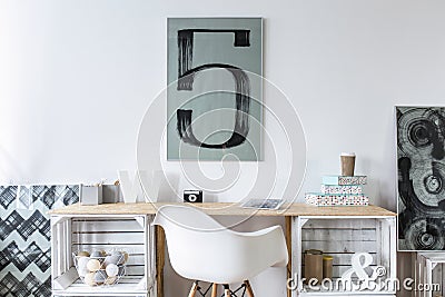 Tidy wooden desk in stylish hipster study room Stock Photo