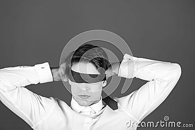 Tie on face and eyes of young blindfolded man, businessman Stock Photo