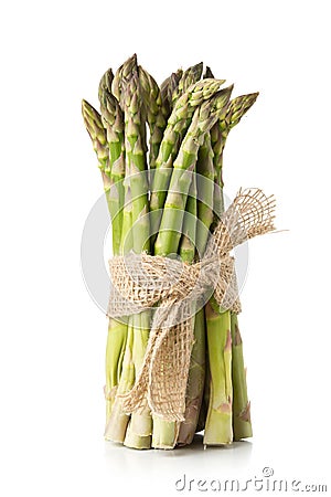 Tied bundle of fresh cut raw, uncooked green asparagus vegetable Stock Photo