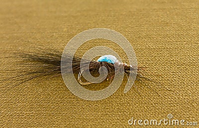 Tied flies, bait for outdoor activities, fly fishing. Do-it-yourself accessory for catching insects with your own hands. Colorful Stock Photo