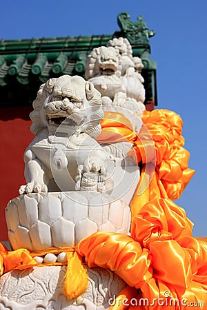 Tied with a red satin of stone lions, close-up Stock Photo