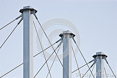 Tied Suspension Roof Cables, Three Tall Grey Masts, Cable-suspended Swooping Rooftop Pylon Anchors, Pale Blue Summer Sky, Large Stock Photo