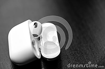 Tiffin, Iowa - 6.2022 - Missing Apple AirPod with a charging case next to it. Editorial Stock Photo